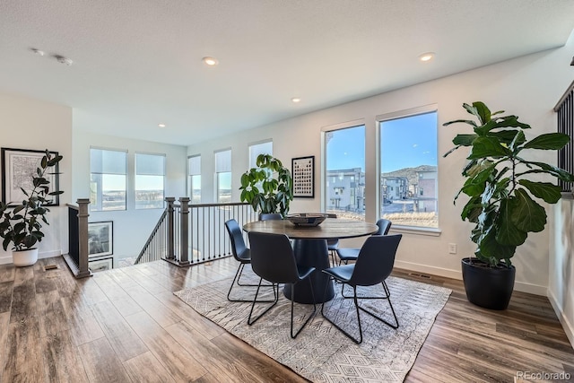 dining space with recessed lighting, baseboards, and wood finished floors