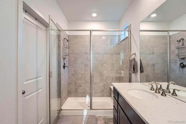 bathroom with a stall shower and vanity