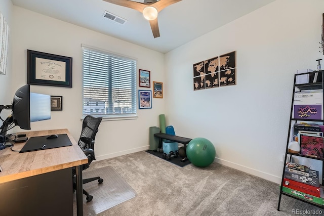 carpeted home office featuring a ceiling fan, visible vents, and baseboards