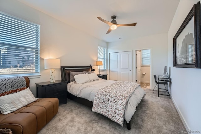 bedroom with a ceiling fan, baseboards, carpet flooring, and ensuite bathroom