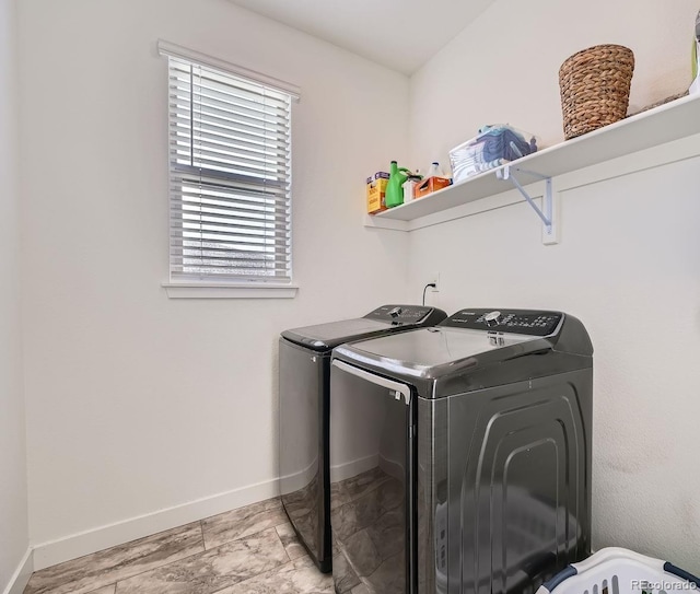 laundry room with laundry area, baseboards, and separate washer and dryer