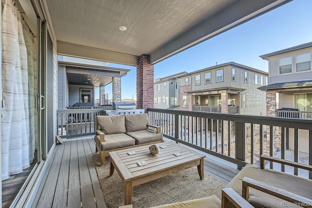 wooden terrace with outdoor lounge area and a grill