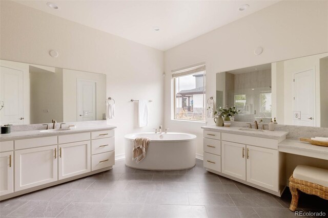 6608 S White Crow Ct, Aurora, CO 80016 - bathroom with a freestanding bath, two vanities, and tile patterned floors