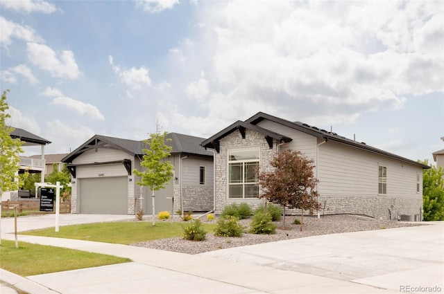 6608 S White Crow Ct, Aurora, CO 80016 - craftsman-style home featuring stone siding, driveway, an attached garage, central AC, and a front lawn