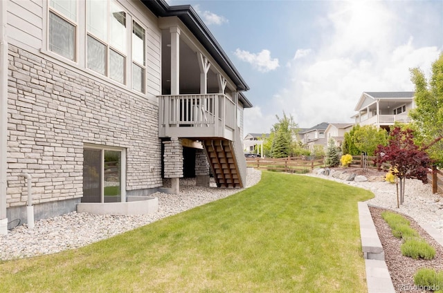 6608 S White Crow Ct, Aurora, CO 80016 - view of green lawn featuring stairway and a wooden deck