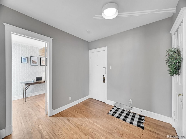 entrance foyer with baseboards and light wood-type flooring