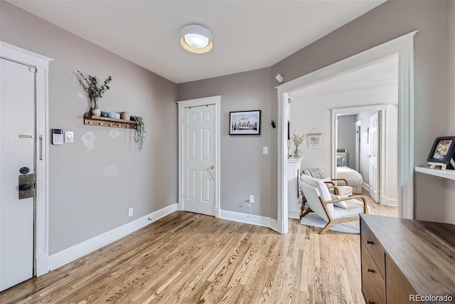 entrance foyer featuring light wood-type flooring and baseboards