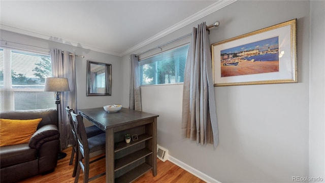 interior space with visible vents, baseboards, crown molding, and wood finished floors