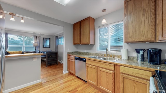 kitchen featuring a healthy amount of sunlight, a sink, tile countertops, and stainless steel dishwasher