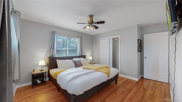 bedroom with a closet, light wood-style flooring, and baseboards