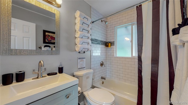 bathroom featuring toilet, shower / bath combo, and vanity