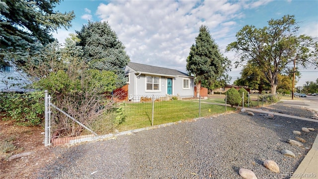 view of front of property with a front lawn, a fenced front yard, and stucco siding