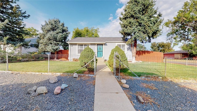 view of front of home featuring a fenced front yard, a front yard, and stucco siding