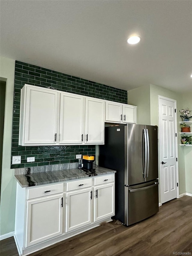 3974 Castle Vista Ln, Castle Rock, CO 80104 - kitchen with freestanding refrigerator, white cabinets, decorative backsplash, dark wood-type flooring, and dark stone countertops