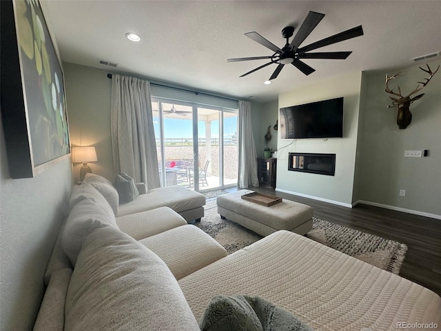3974 Castle Vista Ln, Castle Rock, CO 80104 - living area with a ceiling fan, dark wood-type flooring, recessed lighting, and a glass covered fireplace