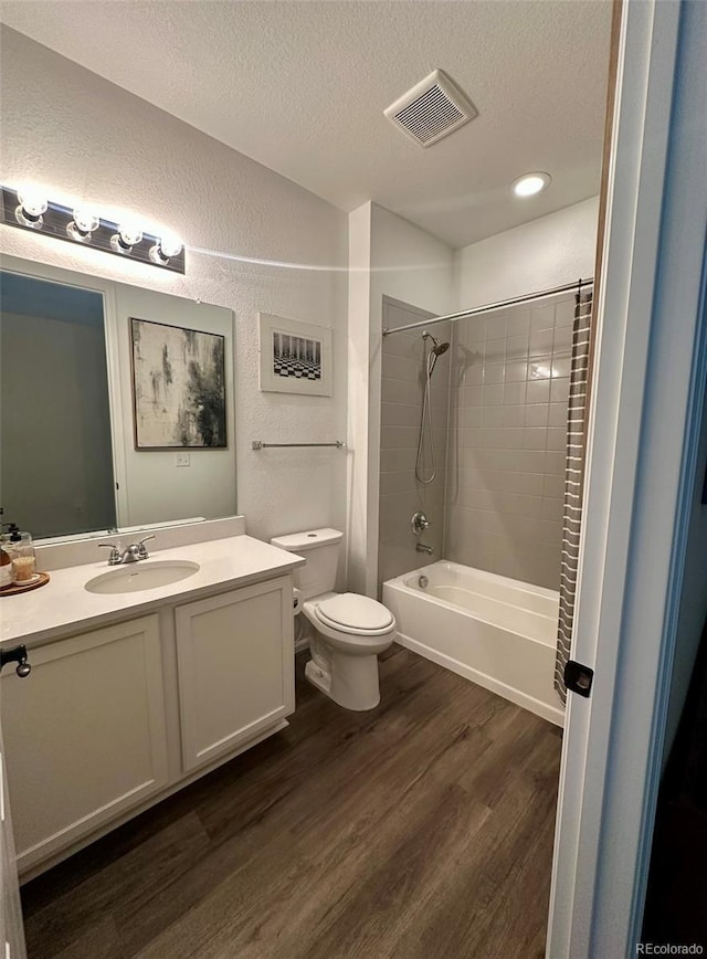 3974 Castle Vista Ln, Castle Rock, CO 80104 - full bath featuring wood finished floors, a textured ceiling, vanity, washtub / shower combination, and a textured wall