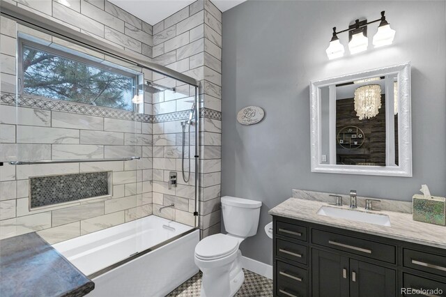 bathroom with shower / bath combination, vanity, toilet, and baseboards