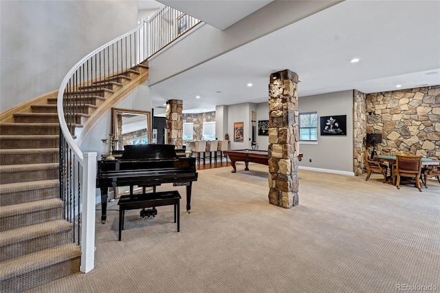 interior space featuring recessed lighting, light carpet, baseboards, stairway, and decorative columns