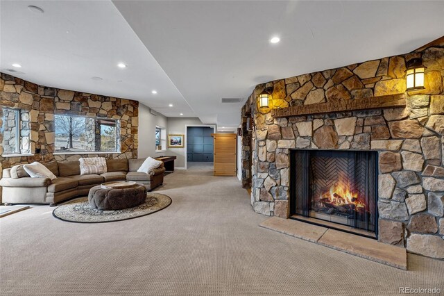 living area featuring recessed lighting, a fireplace, visible vents, and light colored carpet