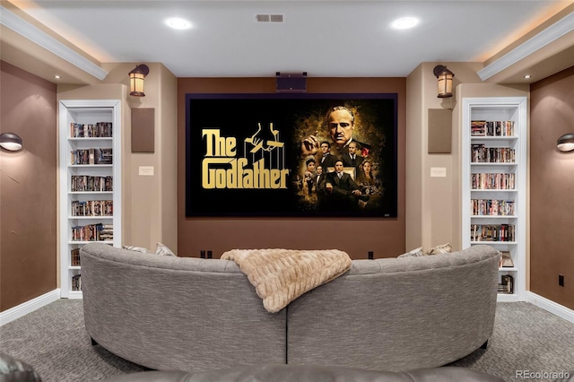 carpeted home theater featuring built in shelves, recessed lighting, visible vents, and baseboards