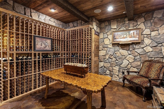 wine room featuring wooden ceiling and beamed ceiling