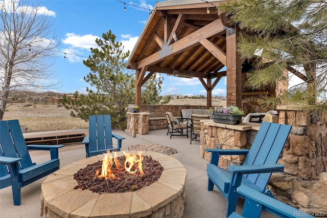 view of patio / terrace with outdoor dry bar, a gazebo, and an outdoor fire pit