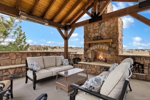 view of patio with a gazebo and an outdoor living space with a fireplace