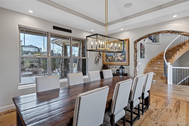 dining area featuring stairs, arched walkways, hardwood / wood-style floors, and recessed lighting