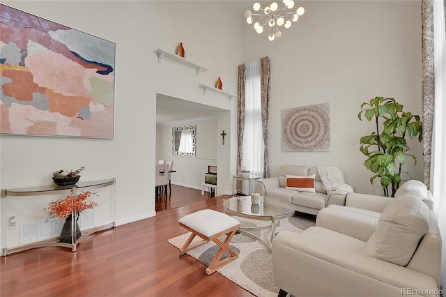 living room with hardwood / wood-style floors and a notable chandelier