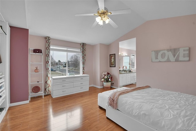 bedroom with multiple windows, ceiling fan, ensuite bath, and light hardwood / wood-style floors