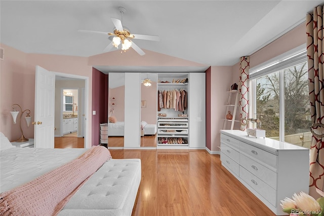 bedroom featuring ceiling fan, vaulted ceiling, light hardwood / wood-style floors, and a closet