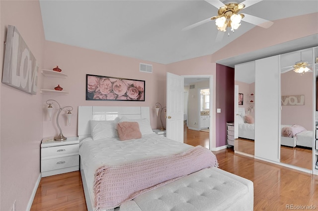 bedroom featuring ceiling fan, a closet, wood-type flooring, and lofted ceiling