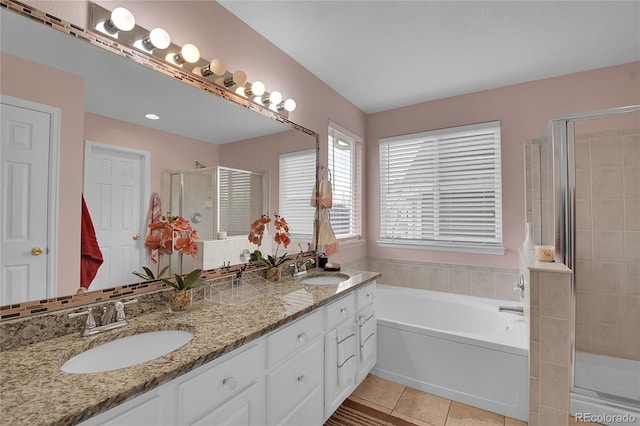 bathroom with tile patterned floors, vanity, and shower with separate bathtub