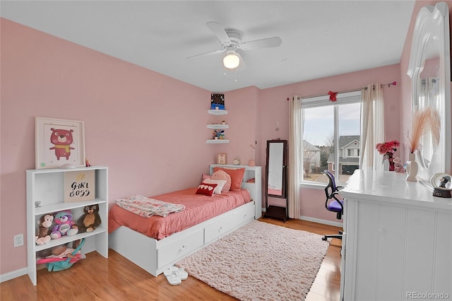 bedroom with ceiling fan and light wood-type flooring