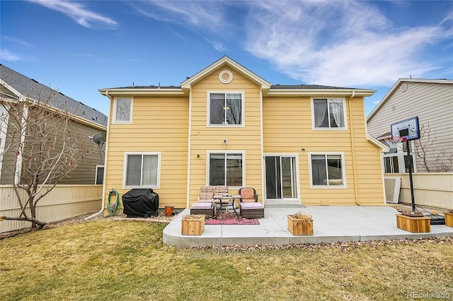 rear view of property with a yard and a patio