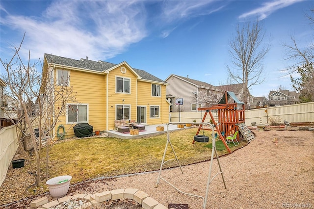 back of property with a patio, a playground, and a lawn