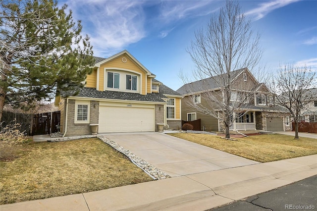 view of property with a garage and a front yard