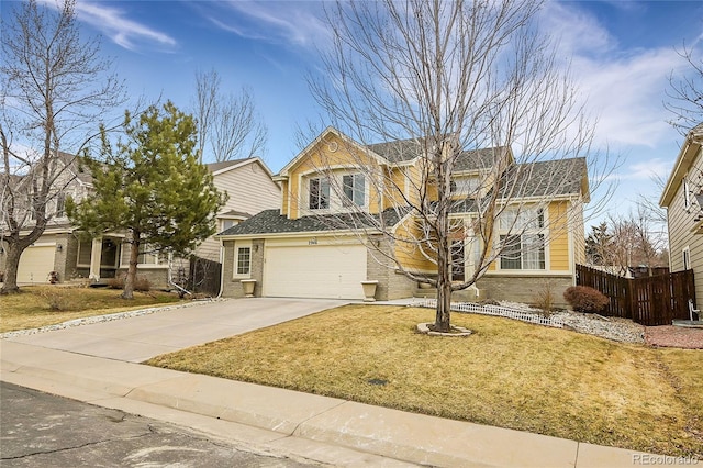 view of front of property with a garage and a front lawn