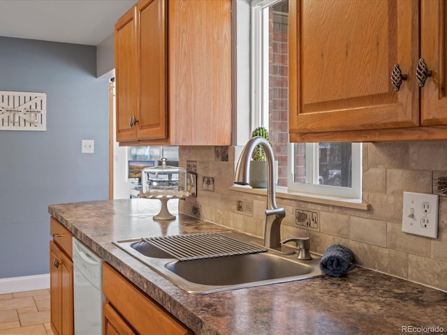 kitchen featuring a sink, dark countertops, and dishwasher