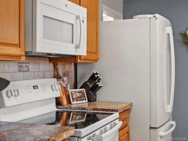 kitchen with white appliances and backsplash