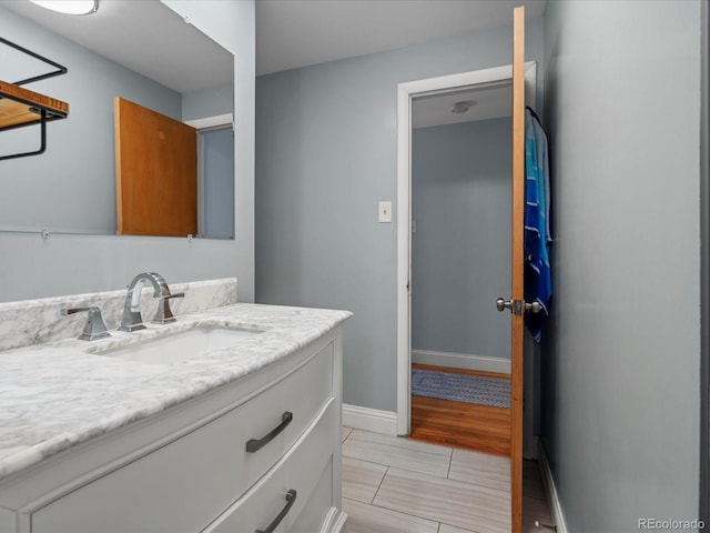 bathroom with vanity and baseboards