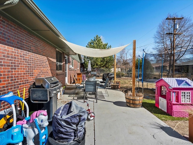 view of patio featuring grilling area and a trampoline