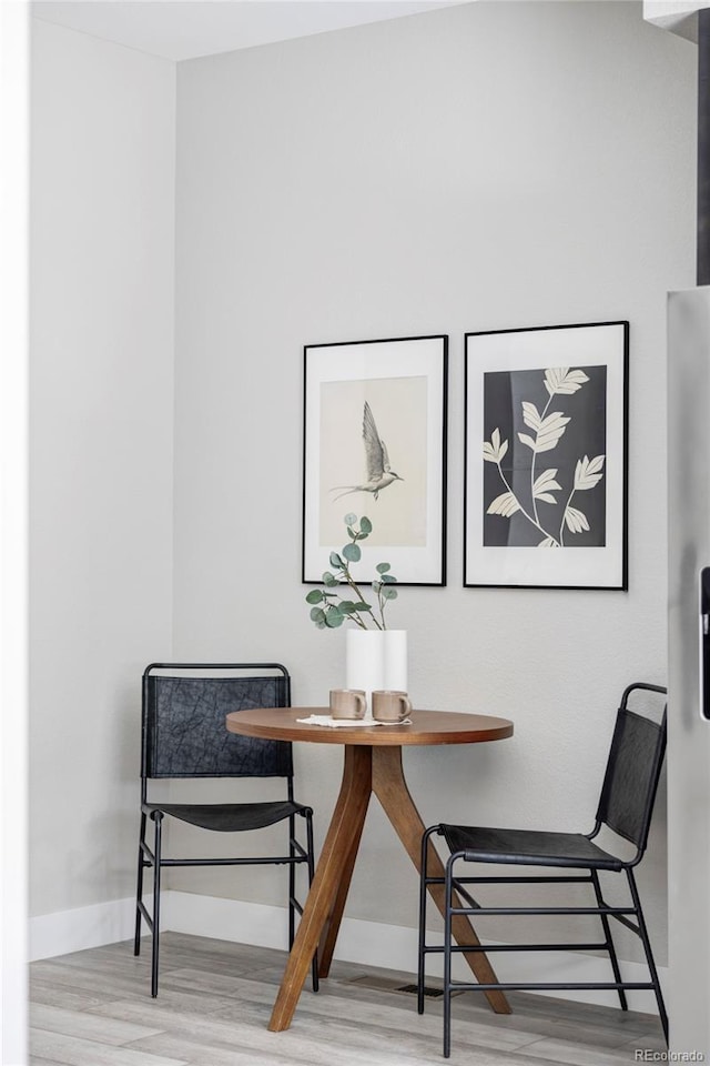 interior space with breakfast area and hardwood / wood-style floors