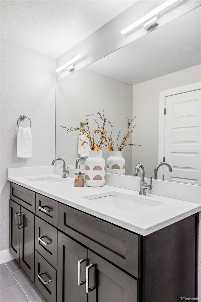 bathroom featuring vanity and a textured ceiling