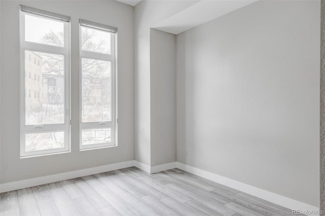 unfurnished room with light hardwood / wood-style flooring