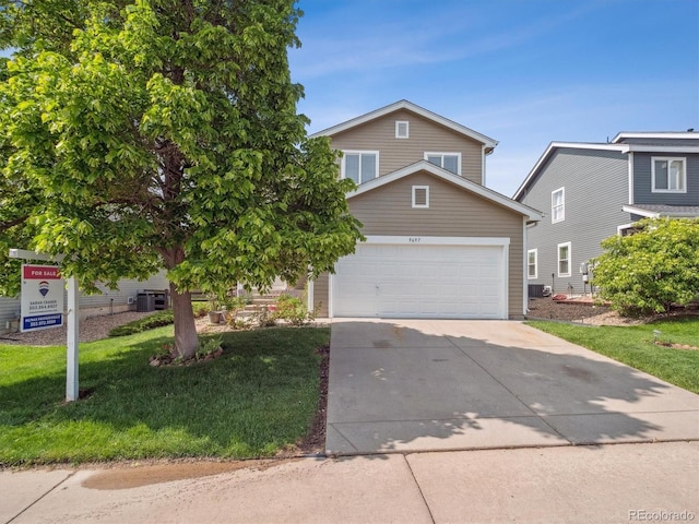 9697 Marmot Ridge Cir, Littleton, CO 80125 - view of front of property featuring an attached garage, concrete driveway, and a front yard