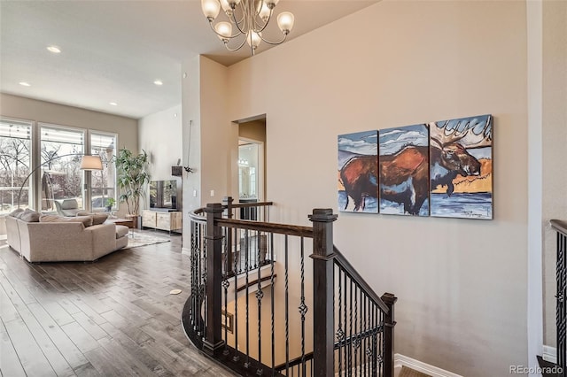 12114 Alcott St, Westminster, CO 80234 - corridor with an upstairs landing, wood finished floors, a chandelier, baseboards, and recessed lighting
