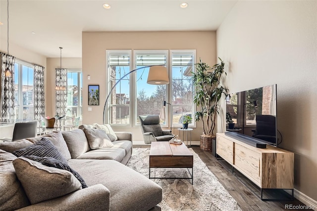 12114 Alcott St, Westminster, CO 80234 - living area featuring dark wood-style floors, recessed lighting, and baseboards