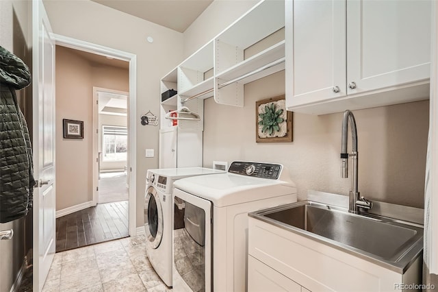 12114 Alcott St, Westminster, CO 80234 - laundry room featuring washing machine and dryer, cabinet space, and baseboards