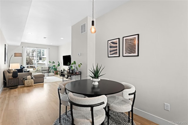 dining area featuring recessed lighting, baseboards, visible vents, and light wood-type flooring